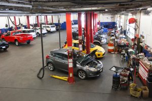 Rows of cars and trucks in auto repair shop